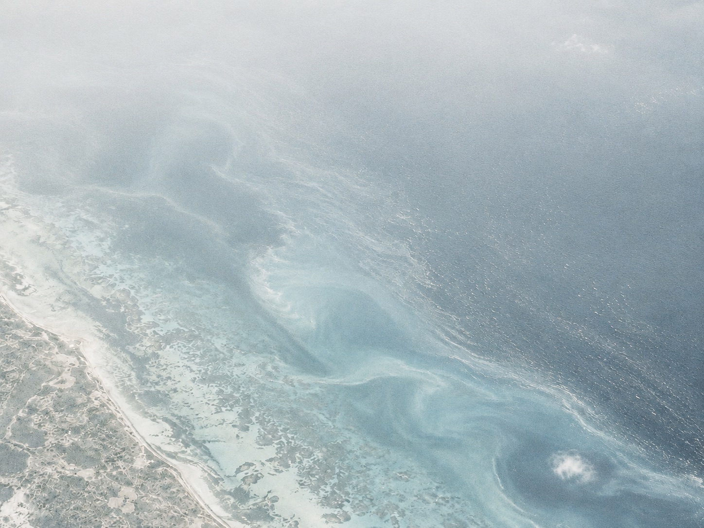 Sunlit aerial view across the ocean surface